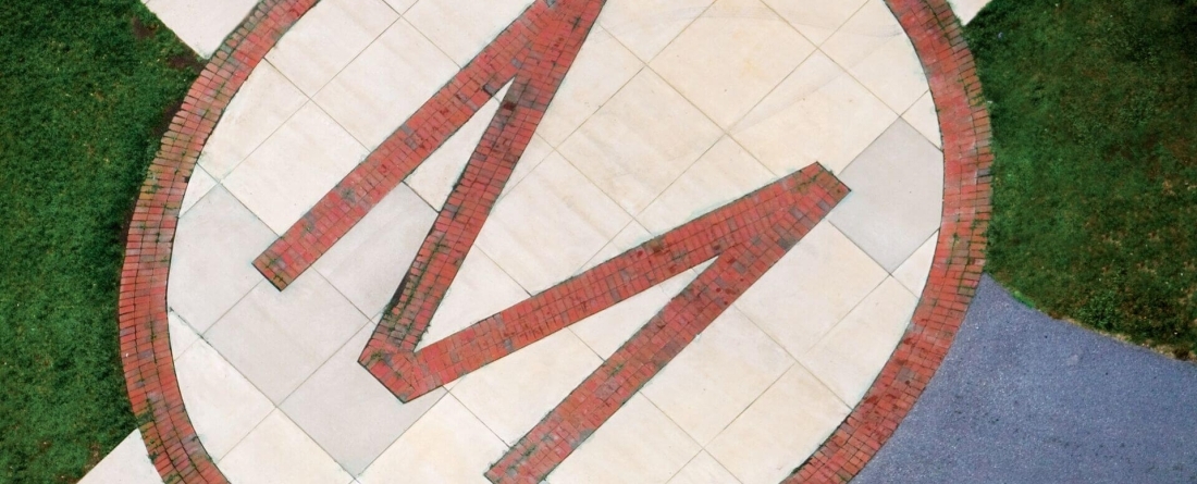 M at sidewalk