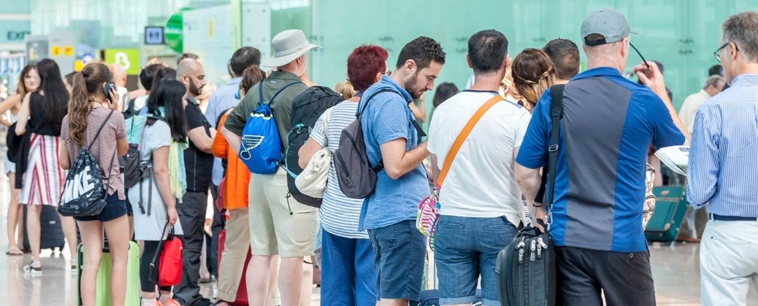 Passengers line up at an airport